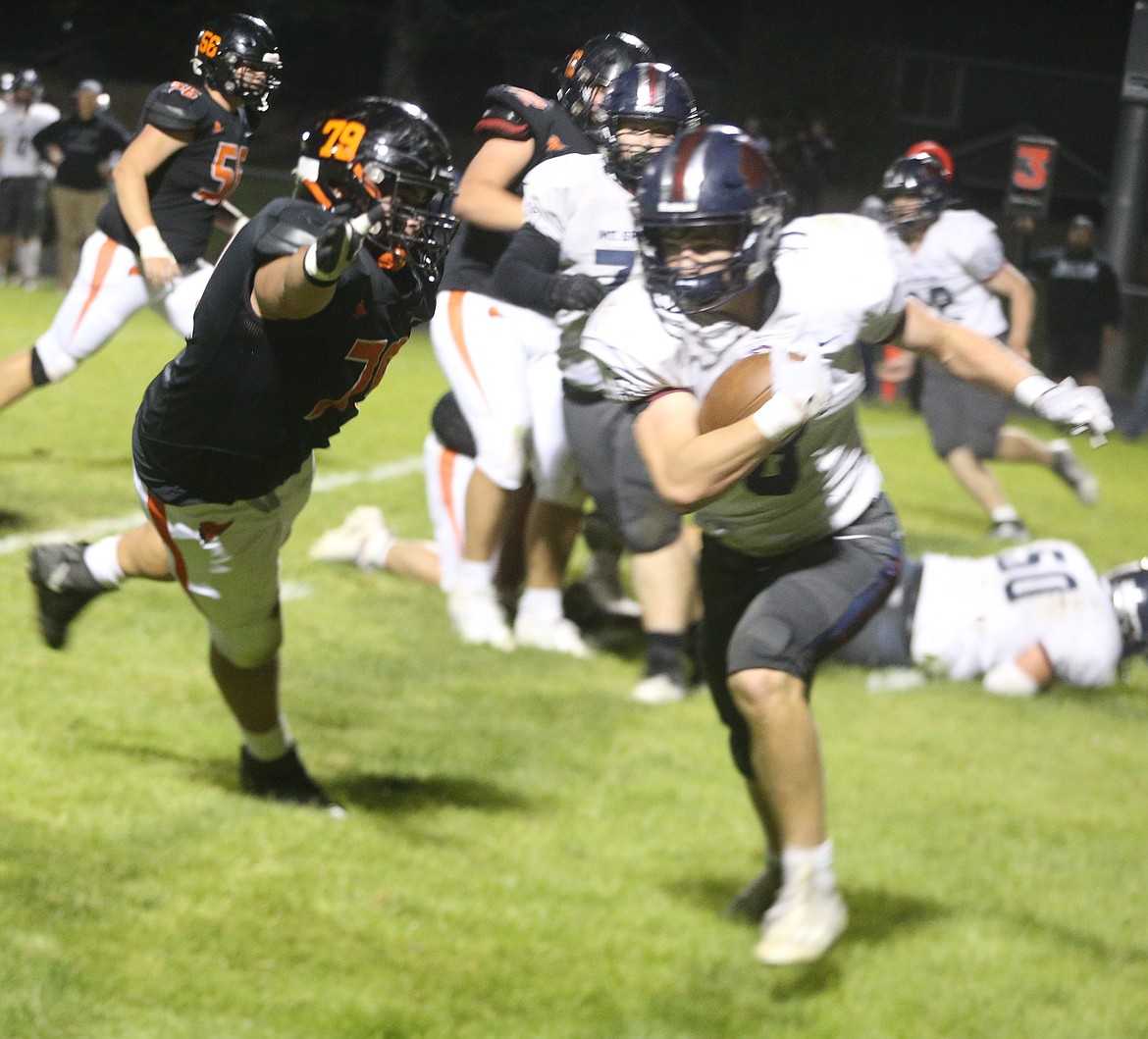 JASON ELLIOTT/Press
Post Falls senior offensive lineman Jackson George attempts to bring down Mt. Spokane linebacker Ben Joireman after Joireman's interception in the fourth quarter of Friday's game at Trojan Stadium.