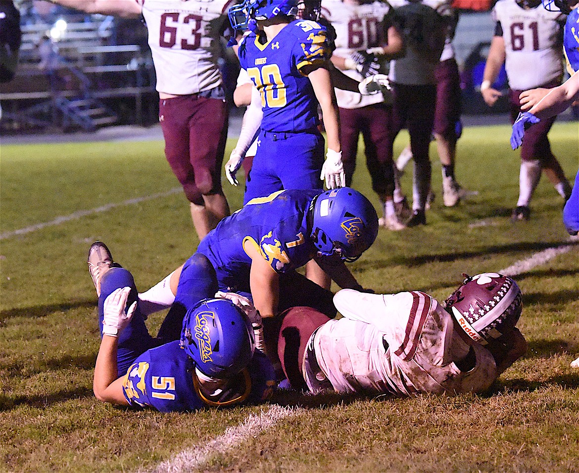 Libby's Ian Thom and Drake Wofford team up to tackle a Butte Central Catholic ball carrier on Friday, Sept. 29, at Loggers Stadium. (Scott Shindledecker/The Western News)