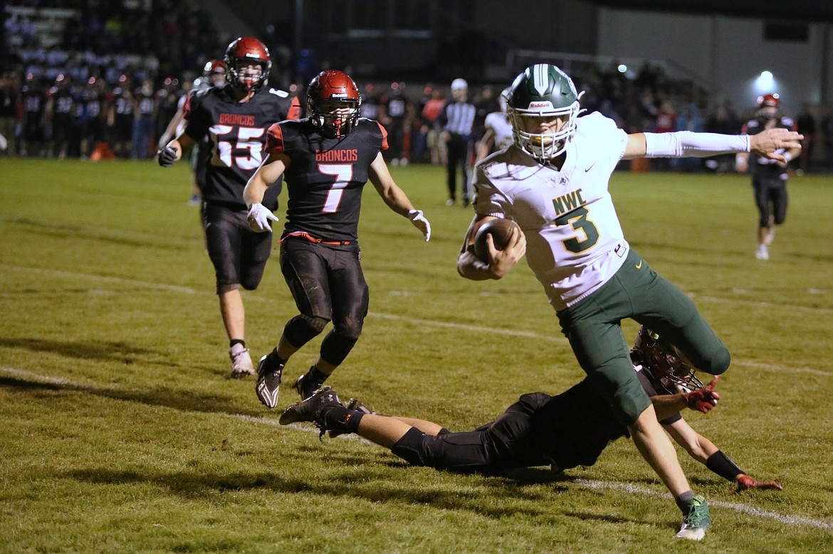 Northwest Christian quarterback Titus Spuler runs into the end zone for the first touchdown of the game on Friday night.