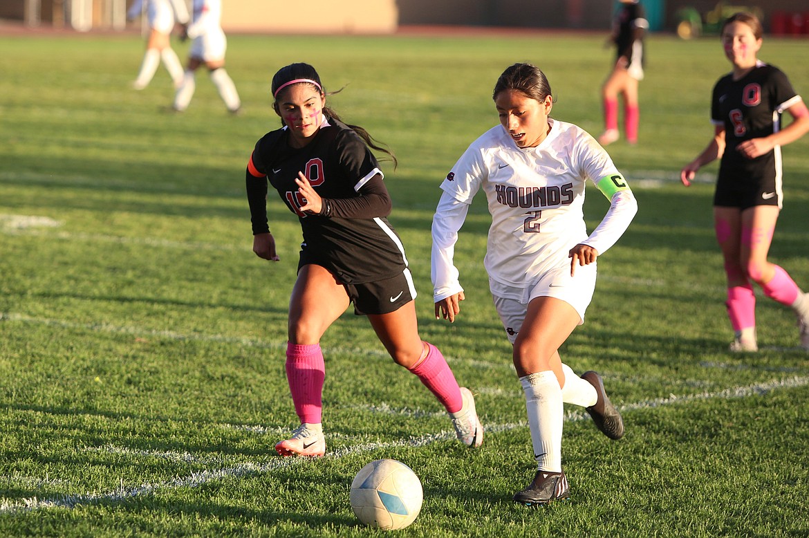 Othello senior Cristina Trinidad keeps up with a Grandview player in the first half against the Greyhounds.