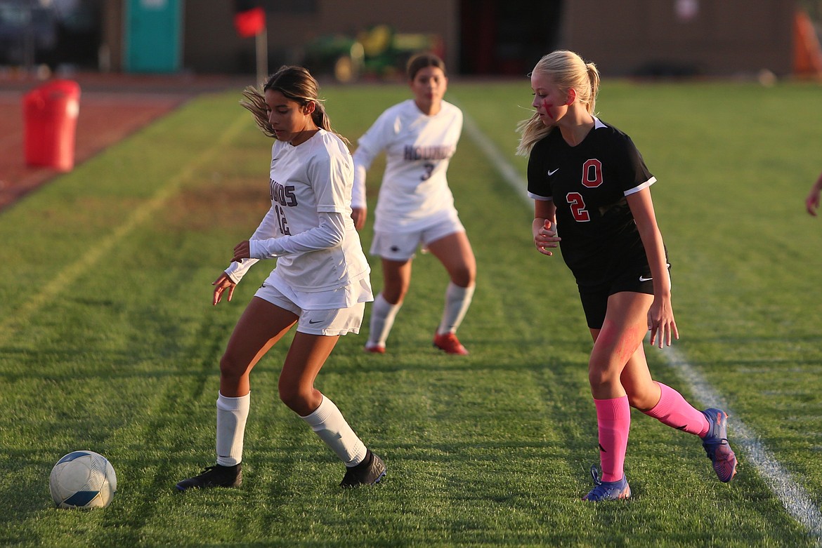 The Othello defense pressures a Grandview forward toward the boundary in the first half.