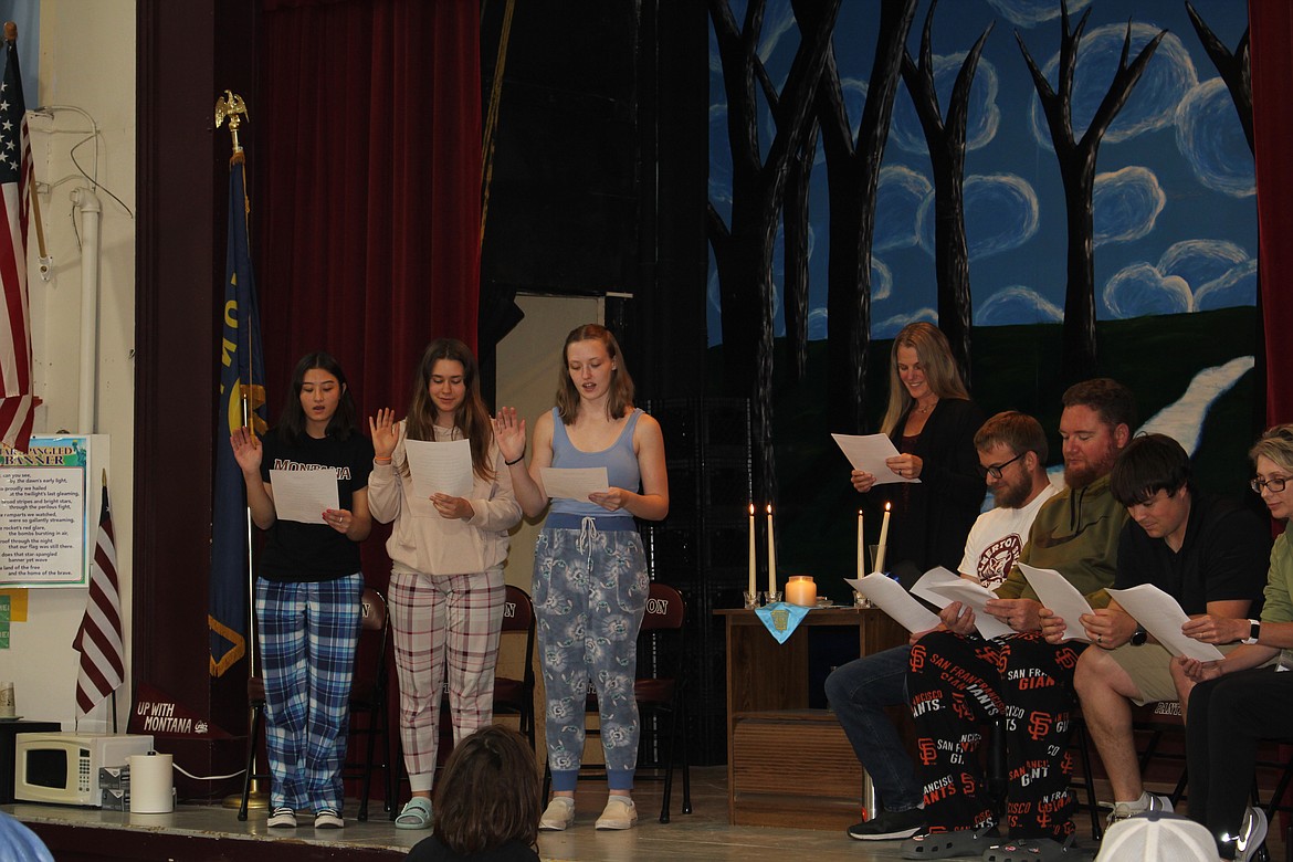 Alberton School students Anna Dao, Raeleen Czerp-Davis and Lacey Zimmerman recite the pledge of acceptance into the National Honor Society. TK-12 School Counselor Kara Morgan follows along as do the ceremony speakers: Nathan Morris, Principal Chris Whiteman, Jake Sedahl and Rachael Clevenger. (Monte Turner/Mineral Independent)