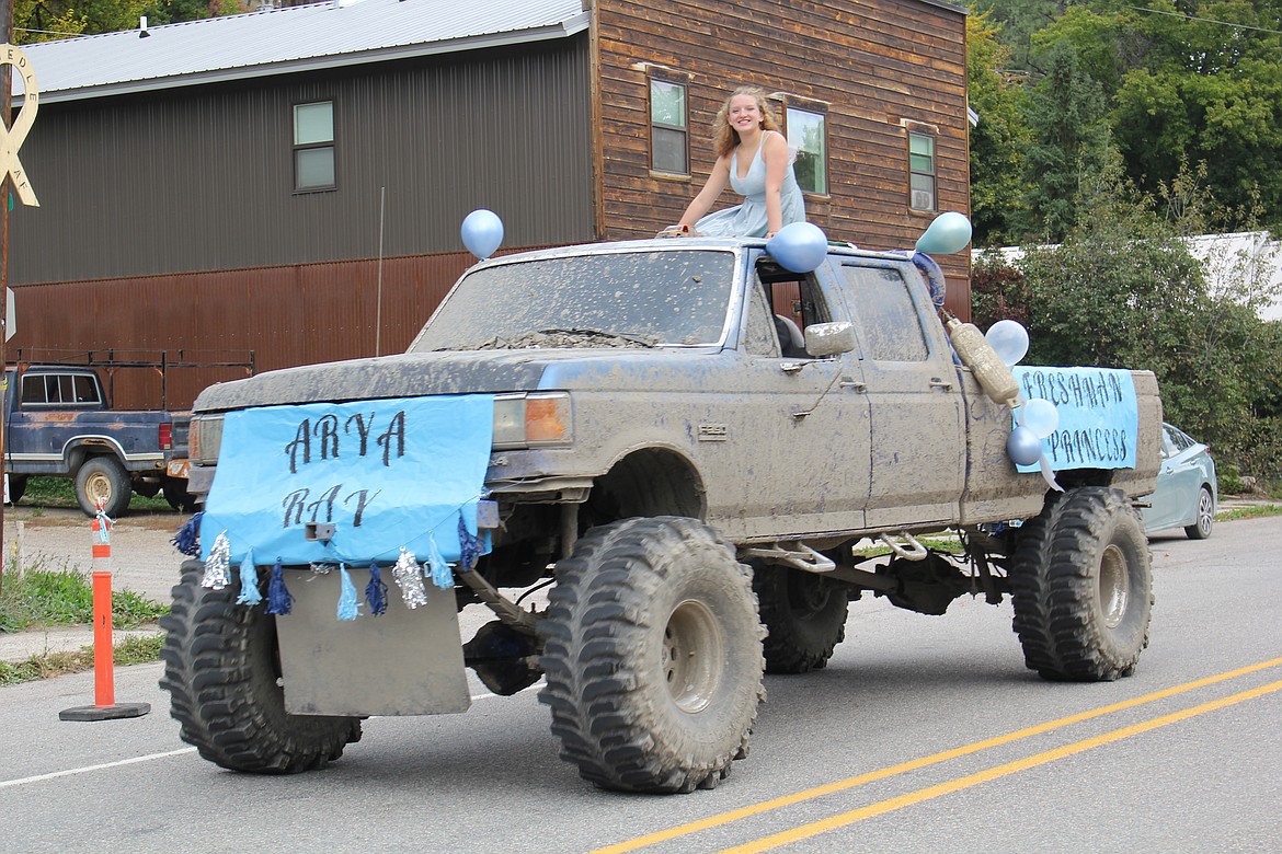 The freshman princess rides on top of a mud caked pickup in the homecoming parade. (Monte Turner/Mineral Independent)