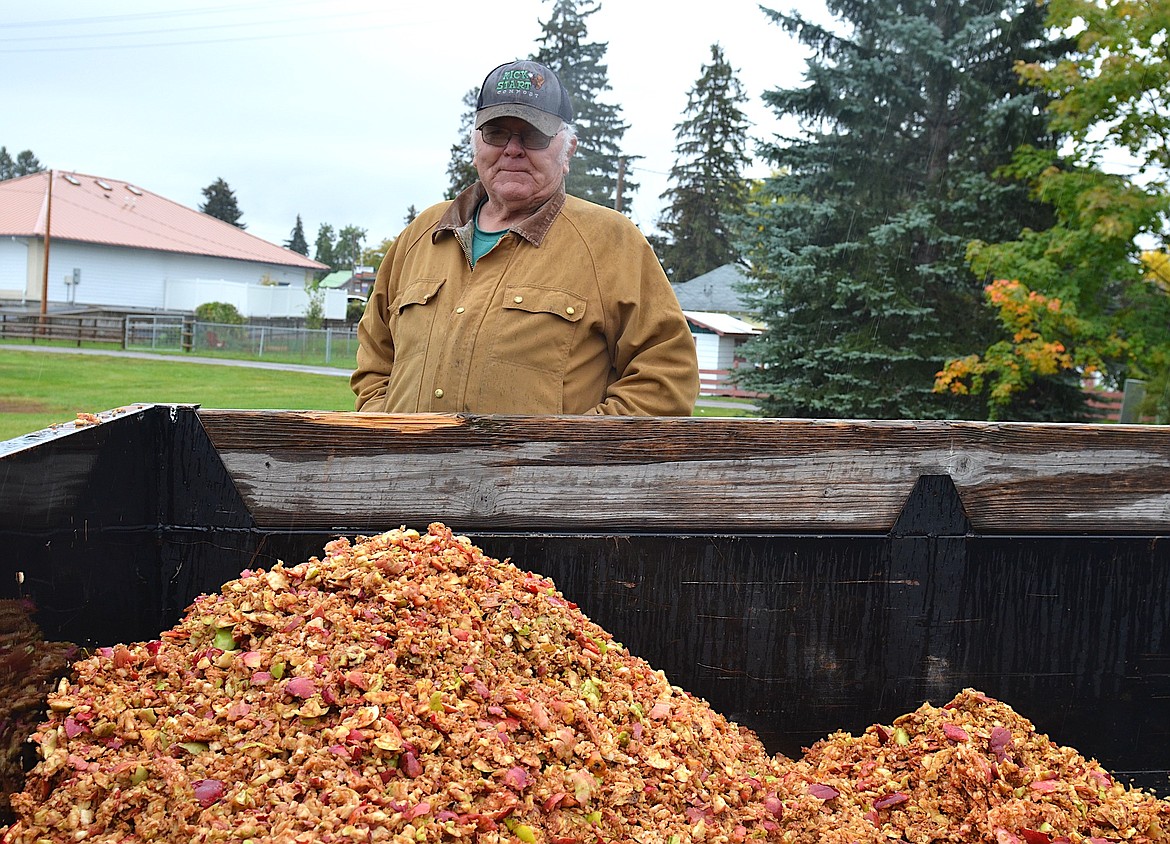 Bob Bell transforms the apple pulp leftover from Saturday's Harvest Festival in Ronan into Kickstart Compost. (Kristi Niemeyer/Leader