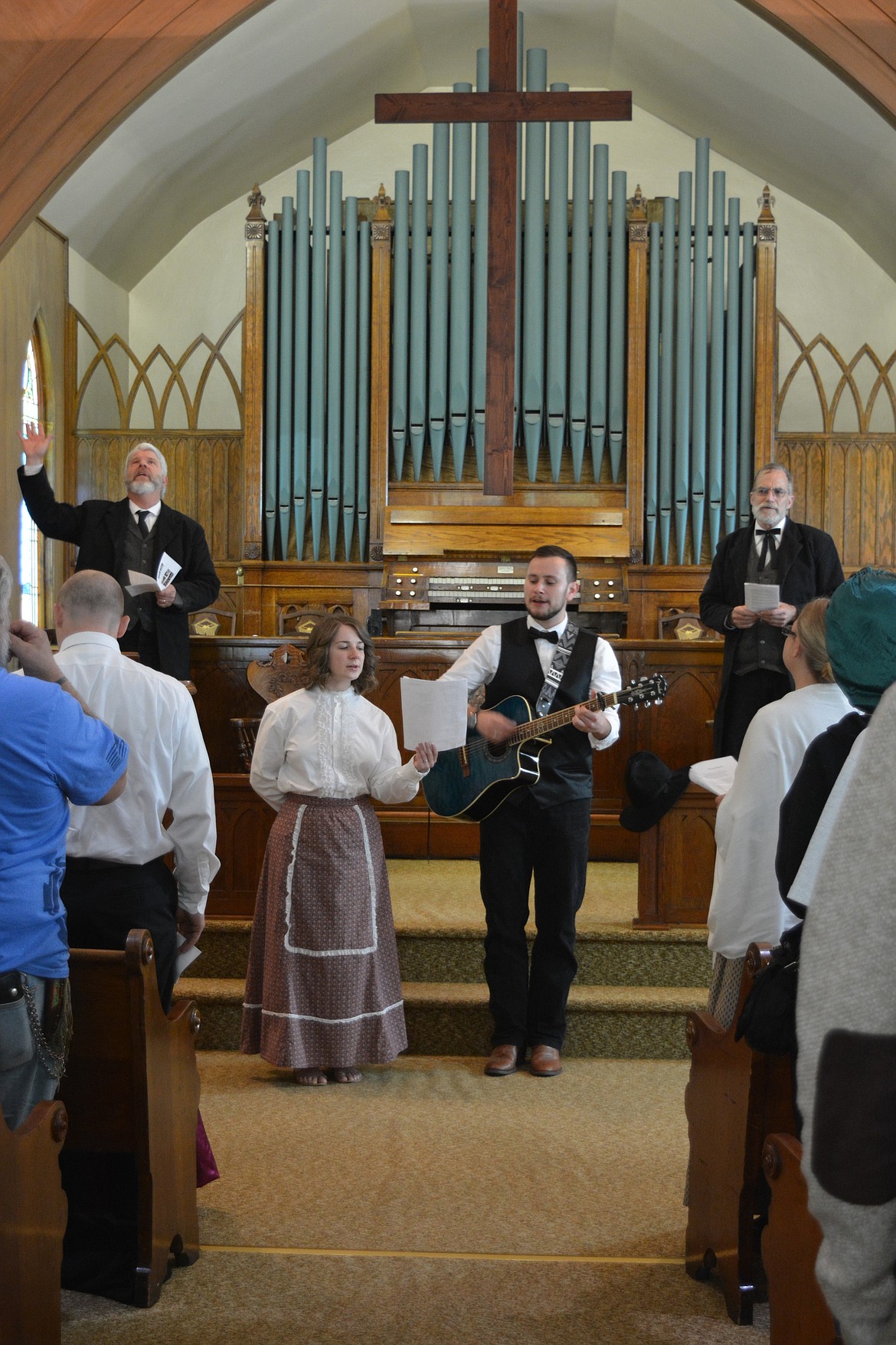 Amy and Patrick Soares de Rocha lead hymns during the old time religion service as Chuck Cushman and Brian Anderson sing along at the Prayer Station in Wallace.