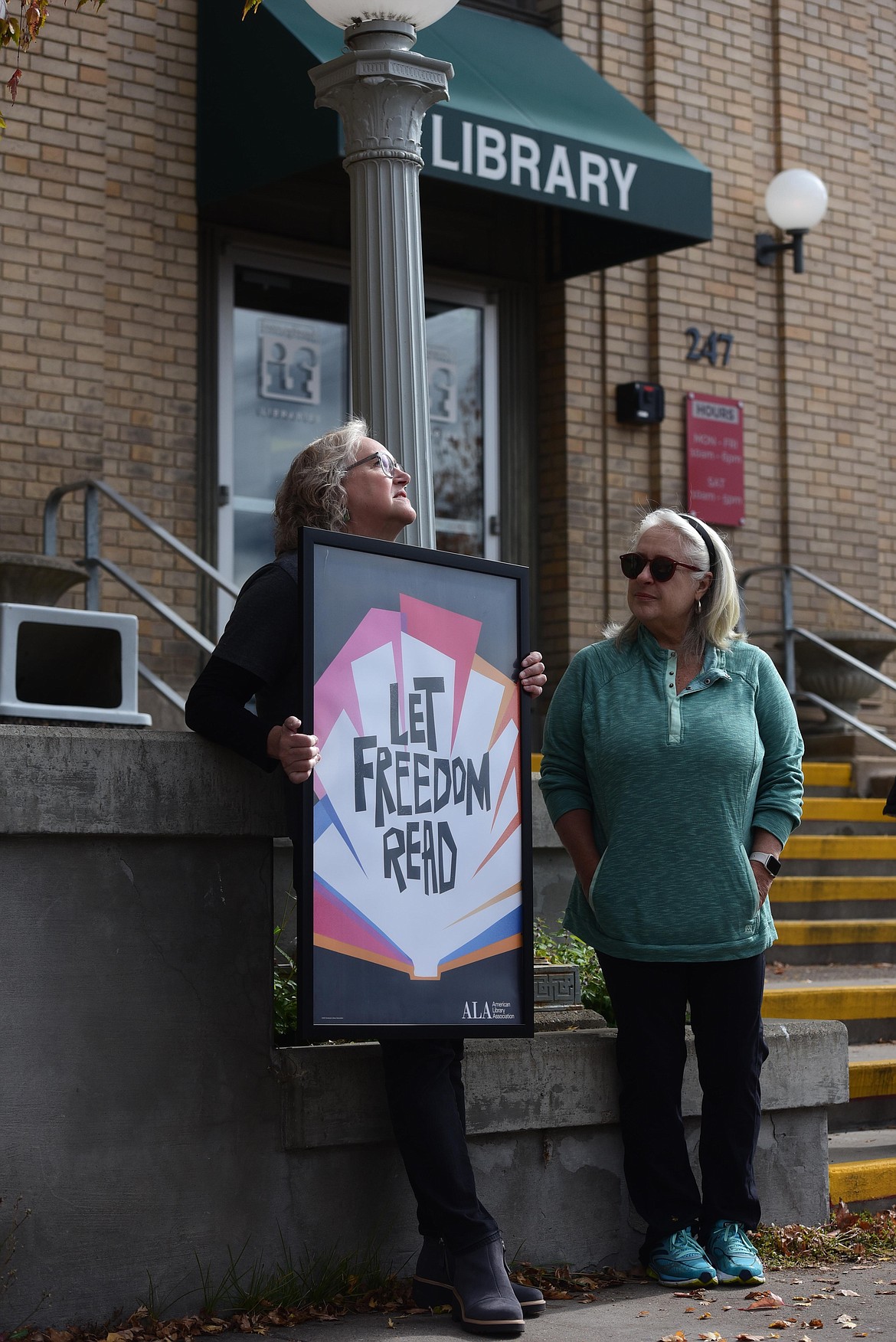 Valeri McGarvey, a Kalispell resident and library patron, holds a sign in support of Banned Books Week outside the Kalispell branch of ImagineIF Libraries on Monday, Oct. 2. (Derrick Perkins/Daily Inter Lake)
