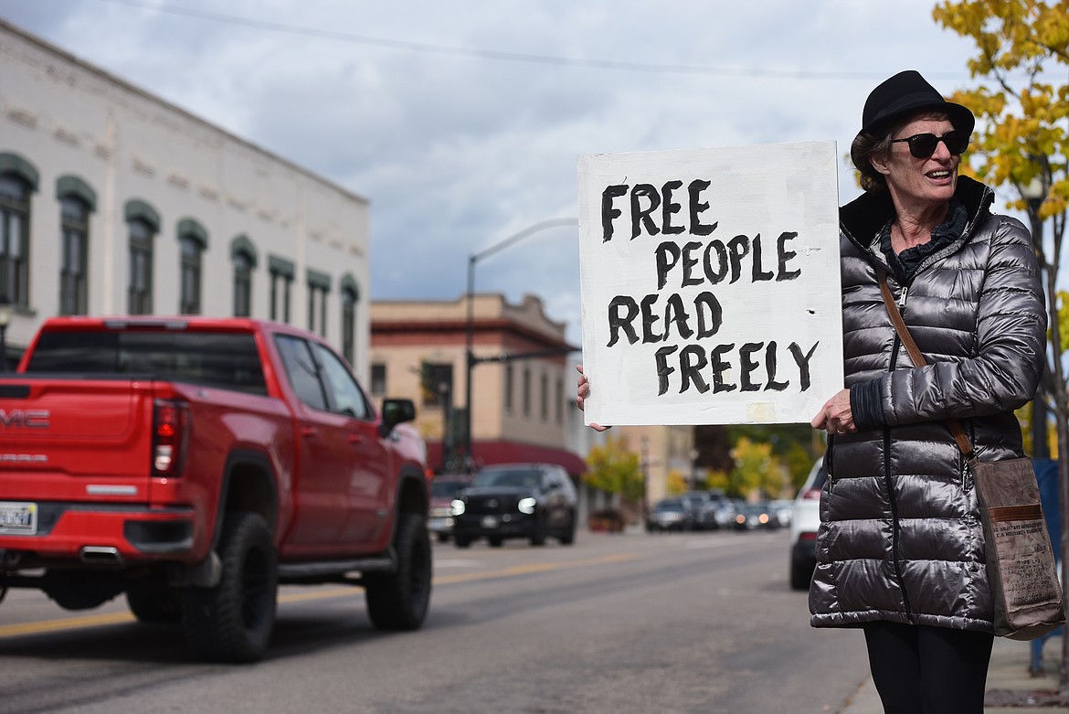 Pam Kron holds a sign in support of Banned Books Week at a rally outside of the Kalispell branch of ImagineIF Libraries on Monday, Oct. 2. (Derrick Perkins/Daily Inter Lake)