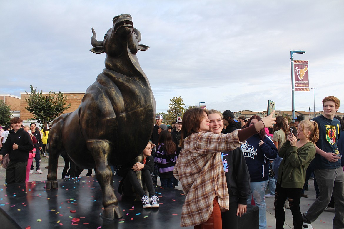 Students stop for selfies and pictures of the new statue outside MLHS.