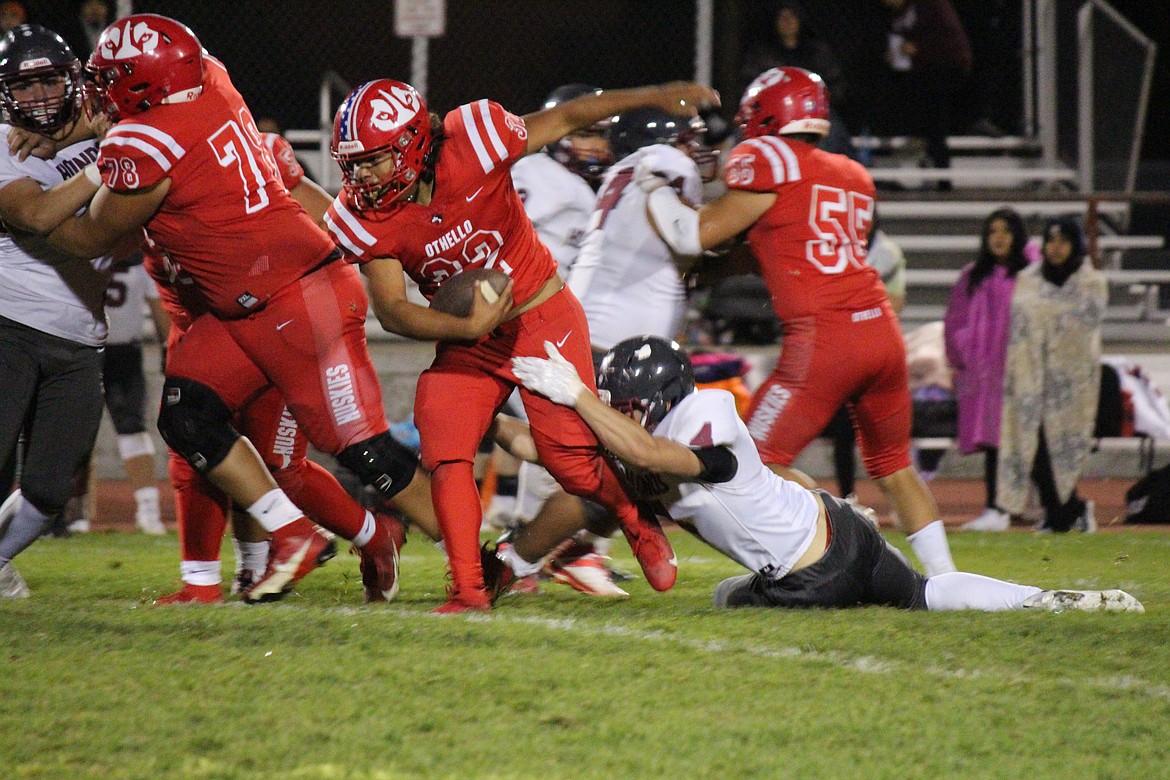 Othello’s Jordan DeLeon (32) breaks the tackle of a Grandview defender.