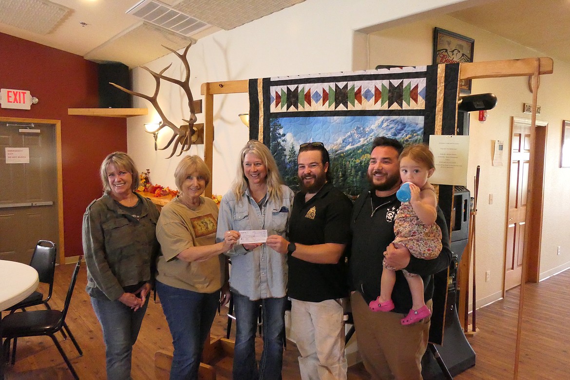 Elks members Stephanie Whisenhunt, Christine Munday, Beth Moore presenting a check for $20,000 to Patrol Base Abbate COO Kevin Fall, Abbate co-founder John Torres and his daughter during a presentation last week at the Elks Lodge in Thompson Falls. (Chuck Bandel/VP-MI)