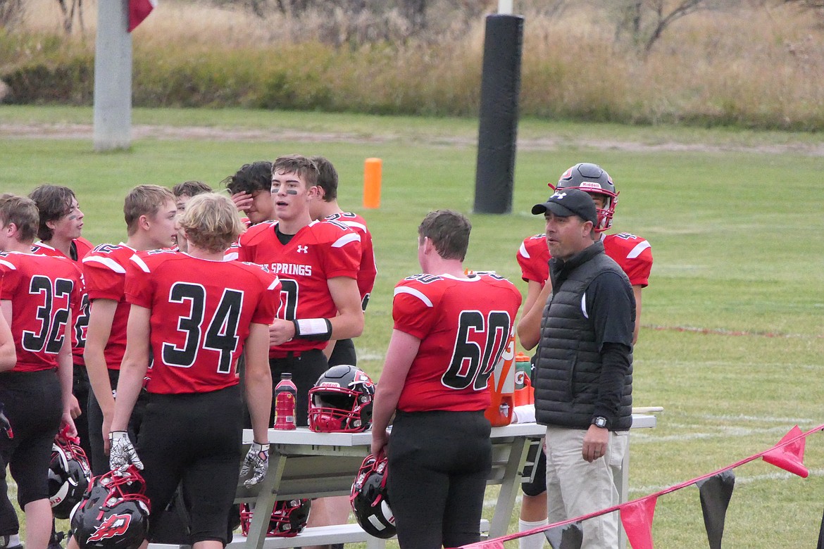 Hot Springs head coach Jim Lawson talks with his team prior to winning his 100th game as a head coach as the Savage Heat blanked White Sulphur Springs 56-0 Friday night in Hot Springs. (Chuck Bandel/VP-MI)