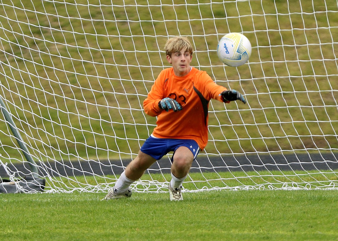 Polson's Robert Merchant hits the penalty kick for a goal against Libby. (Bob Gunderson photo)