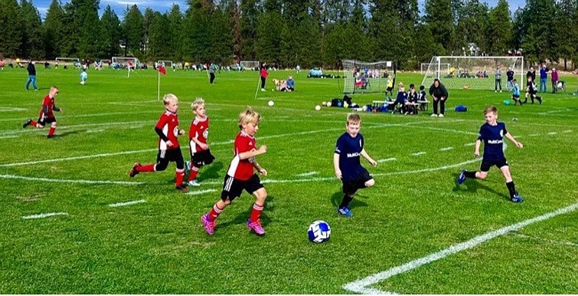 Photo by MANDY MATHENEY
The Timbers North FC 2016 Boys Black soccer team beat the Spokane Sounders North 2016 Boys Green team 9-2 on Saturday. Timbers goals were scored by Mitchell Volland (4), Elijah Cline (3) and Jaxson Matheney (2). Pictured above from left in red is Kevin Sahm, Ryker Bertek, Jaxson Matheney and Elijah Cline as they drive the ball toward the goal.