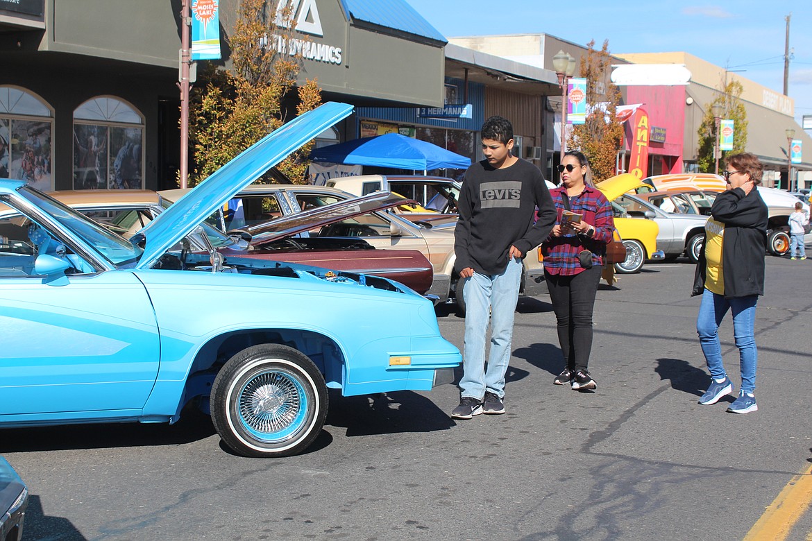 Lowriders gleam in the sun during the car show at the UMANI Festival Saturday.