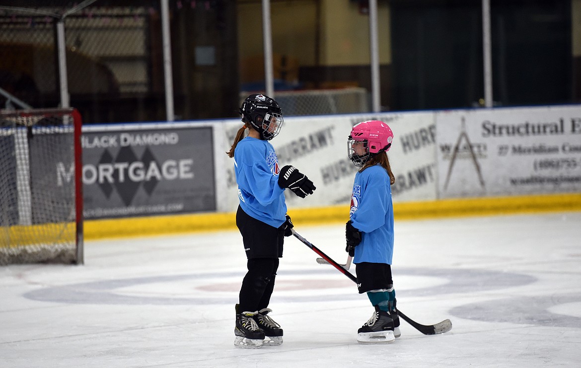 Two players discuss strategy during the final day of the Fall Into Hockey program at the Stumptown Ice Den. (Julie Engler/Whitefish Pilot)