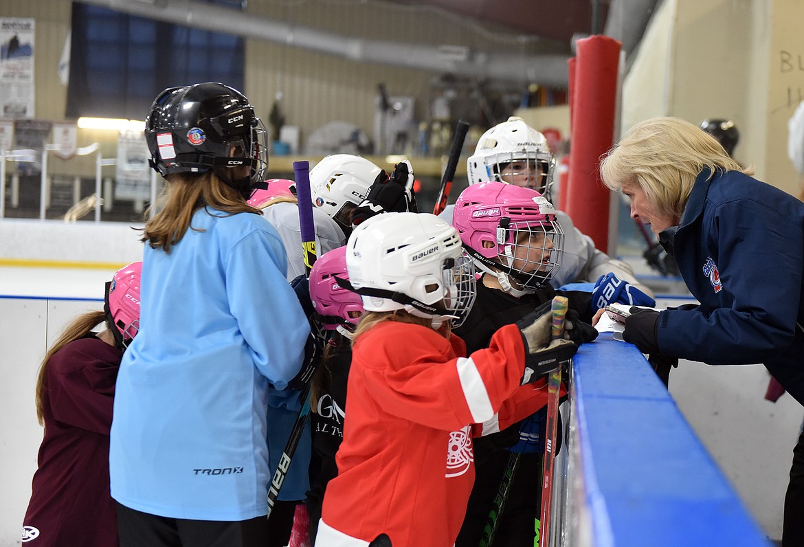 Lini Reading talks with a team of girls at the Fall Into Hockey tournament last week. (Julie Engler/Whitefish Pilot)