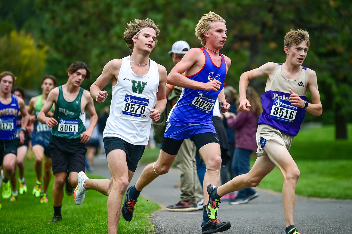 Whitefish's Mason Genovese, Bigfork's Jack Jensen and Polson's Jackson Bontadelli run the course during the Whitefish Invite at Whitefish Lake Golf Club on Tuesday, Sept. 26. (Casey Kreider/Daily Inter Lake)