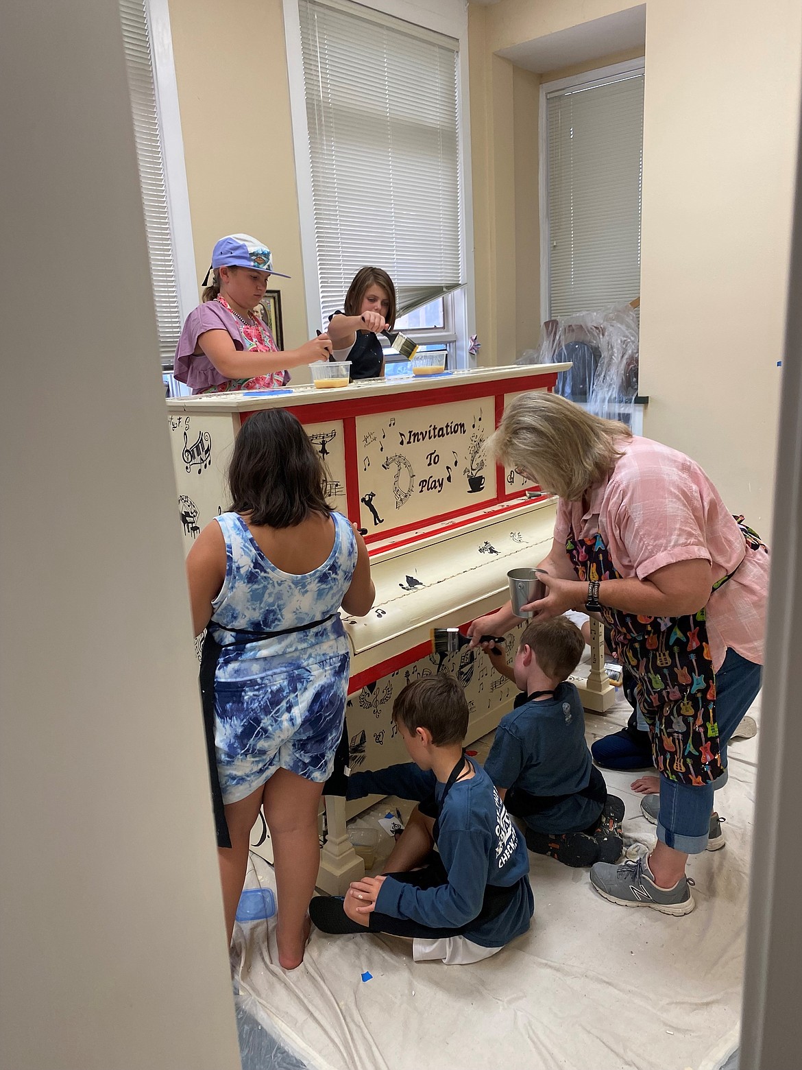 Above, students help work on a piano's decorations. The Music Conservatory of Sandpoint has a fully stocked instrument library with over 200 instruments available to students.