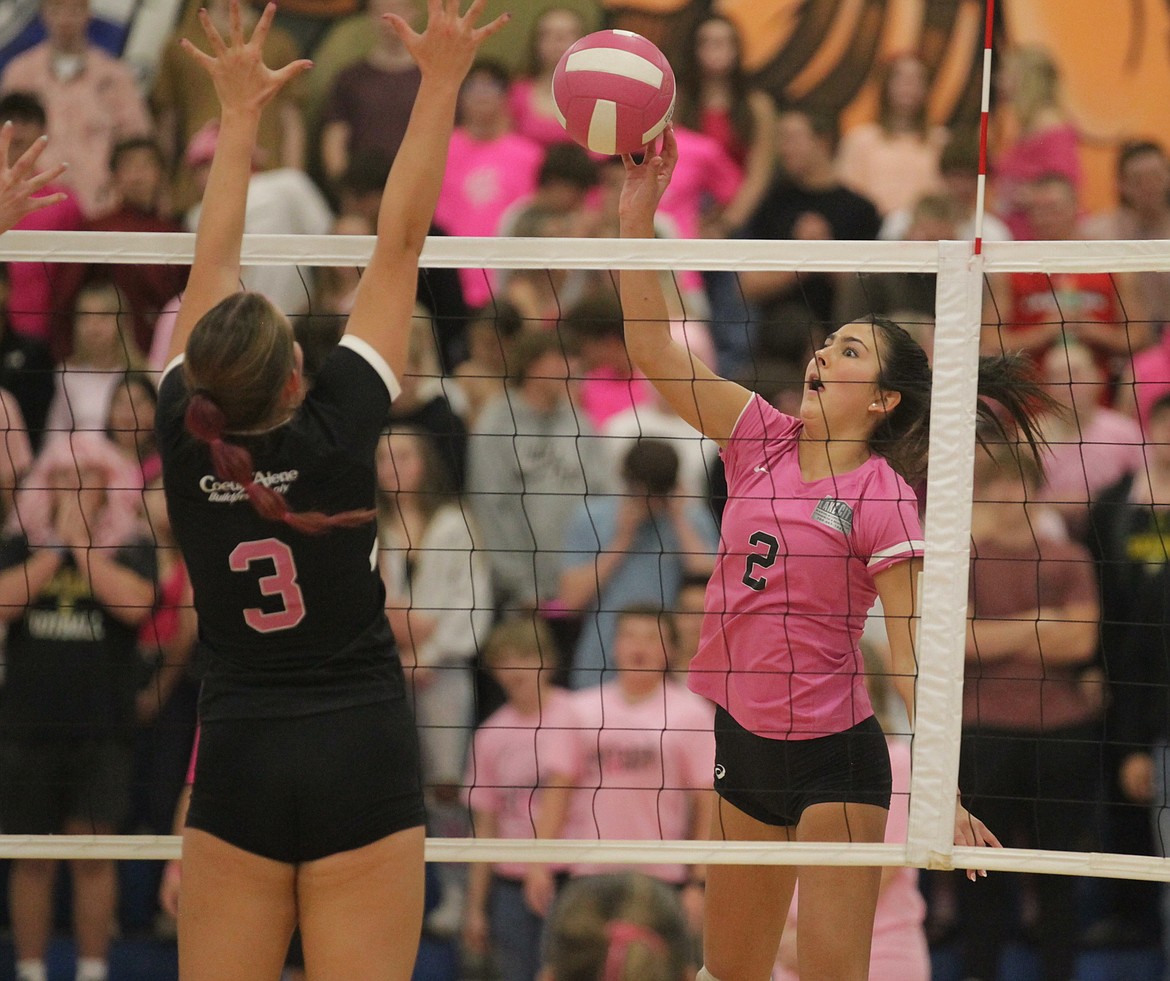 MARK NELKE/Press
Maddie Mitchell (2) of Coeur d'Alene chips a ball over the net as Jenna Sarff (3) of Post Falls defends Tuesday night in the Volleyball 4 the Cure match at Viking Court.