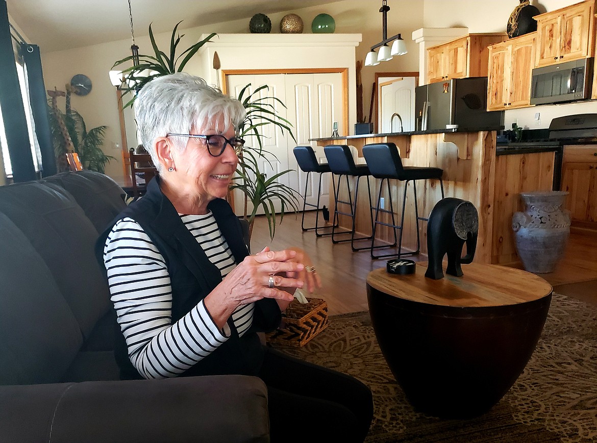 Marji Naaz laughs in her home in Jasper Falls. Nearly all of the decor in her home is from a thrift store, with the exception of most of the furniture.