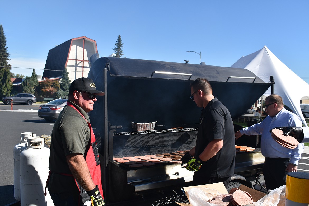 Grant County Sheriff Joe Kriete, left, and other county officials work together to cook up hundreds of burgers and hot dogs for county staff on Wednesday. Grant County deputies, maintenance crews, clerks and administrative staff – to name a few – were present to enjoy much-deserved kudos.