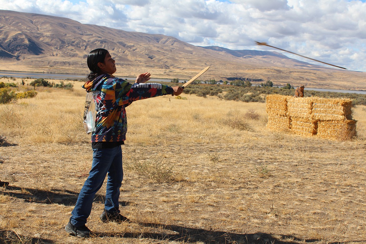 An Archaeology Days participant lets the spear fly with the help of an atlatl.