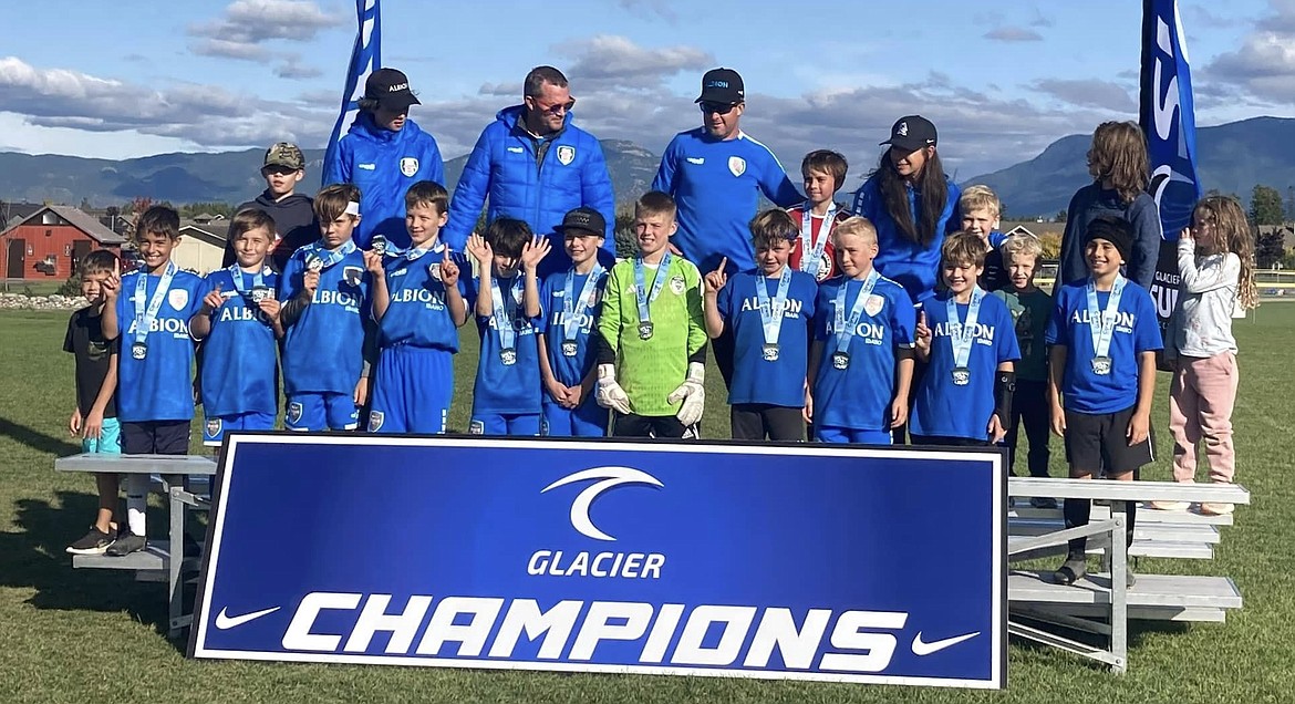 The Albion SC Idaho 2013/14 boys team poses for a photo with their coaches and their biggest fans, their siblings, after winning the Glacier Premier Cup held in Whitefish, Mont. this past weekend.