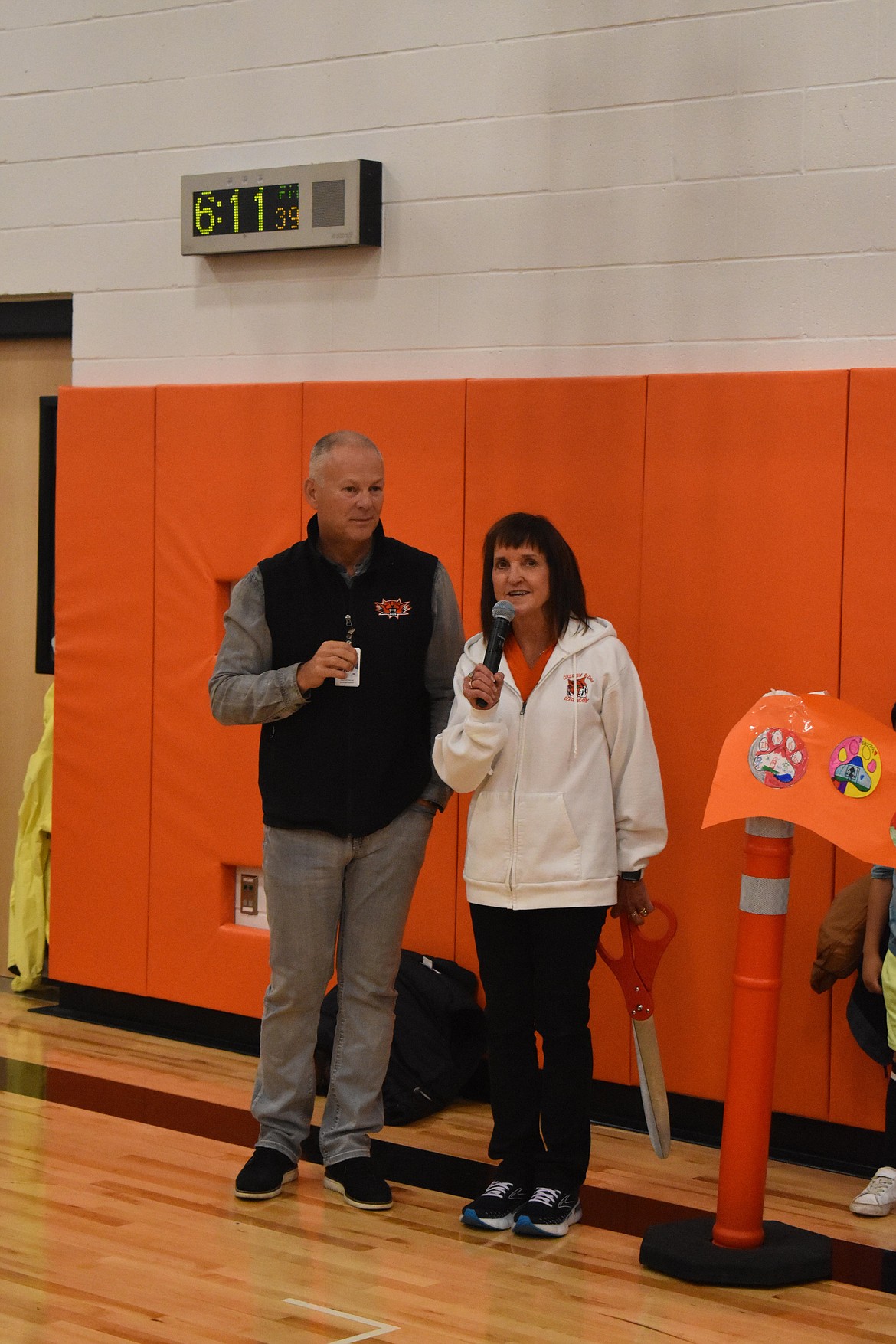 Carrie Wanke, a long-time teacher at Columbia Ridge Elementary, speaks alongside Ephrata School District Superintendent Tim Payne before she cuts the custom-made “ribbon” at the ribbon-cutting ceremony for the campus. The Ephrata School District is celebrating the completion of renovations to the building which modernized it and improved a variety of aspects to the facility, including improved security, a remodeled gym, classroom upgrades and a revved-up cafeteria.