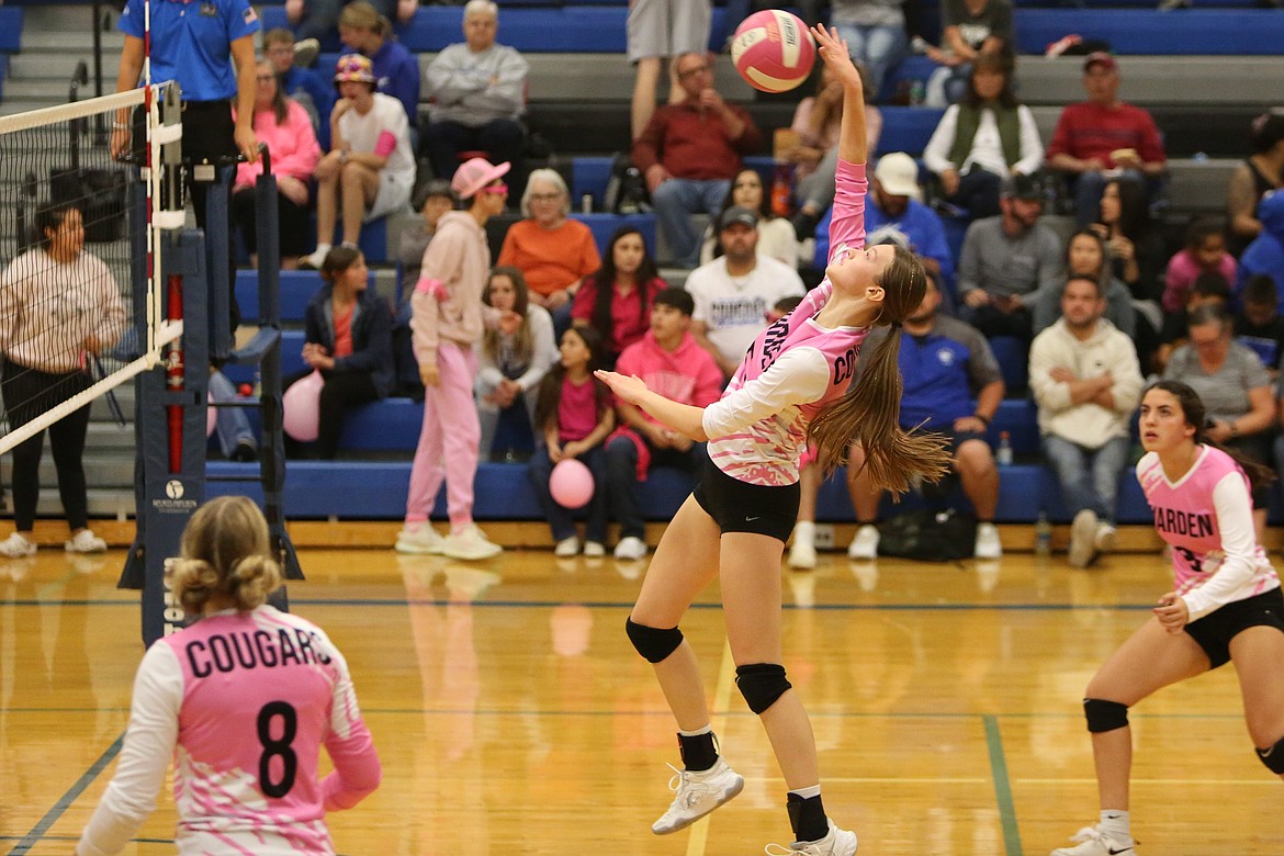 Warden senior Lauren Chamberlain, middle, leaps up to spike the ball against River View.