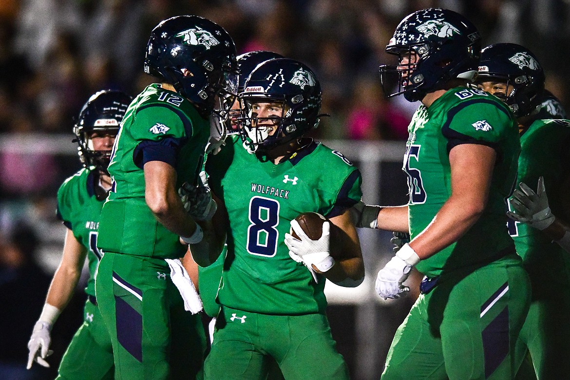 Glacier wide receiver Evan Barnes (8) celebrates with teammates after a 35-yard touchdown reception from quarterback Jackson Presley in the second quarter against Flathead at Legends Stadium on Thursday, Oct. 5. (Casey Kreider/Daily Inter Lake)