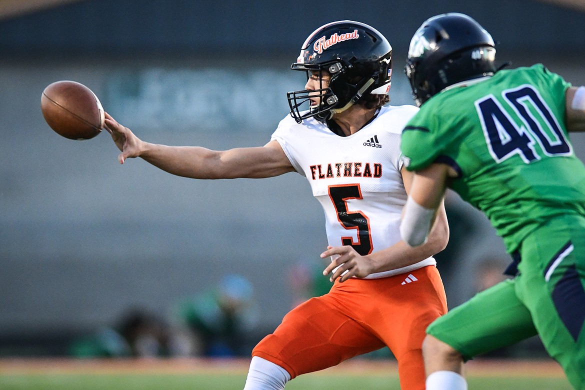 Flathead quarterback Kaleb Sims (5) pitches to tight end Braden Capser on a run in the first quarter against Glacier at Legends Stadium on Thursday, Oct. 5. (Casey Kreider/Daily Inter Lake)