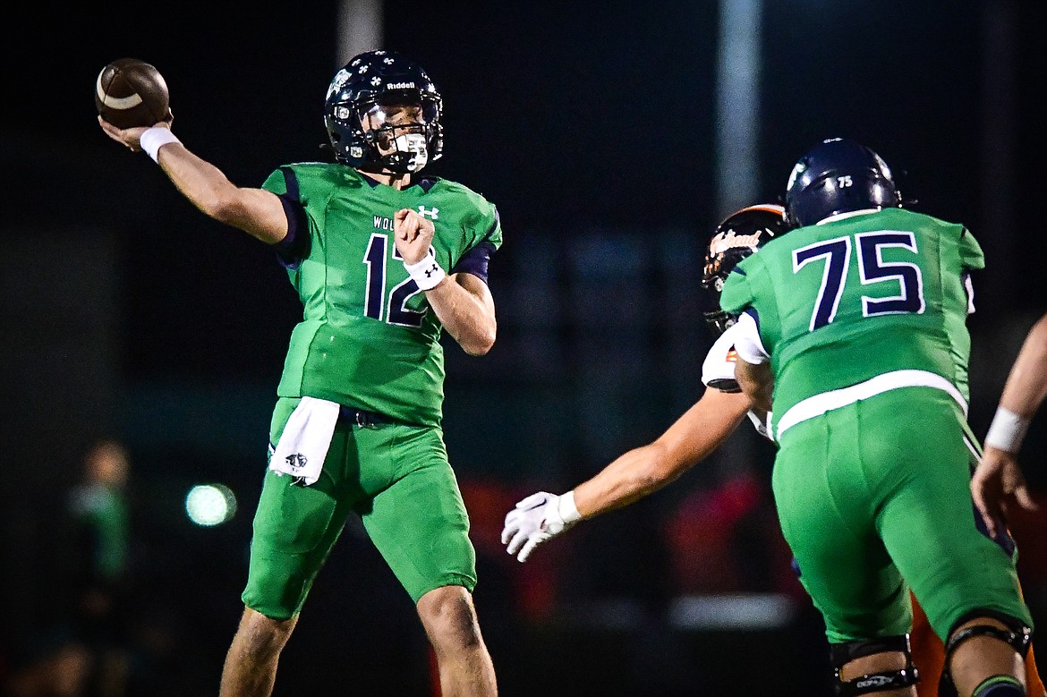 Glacier quarterback Jackson Presley (12) throws a 35-yard touchdown pass to wide receiver Evan Barnes in the second quarter against Flathead at Legends Stadium on Thursday, Oct. 5. (Casey Kreider/Daily Inter Lake)