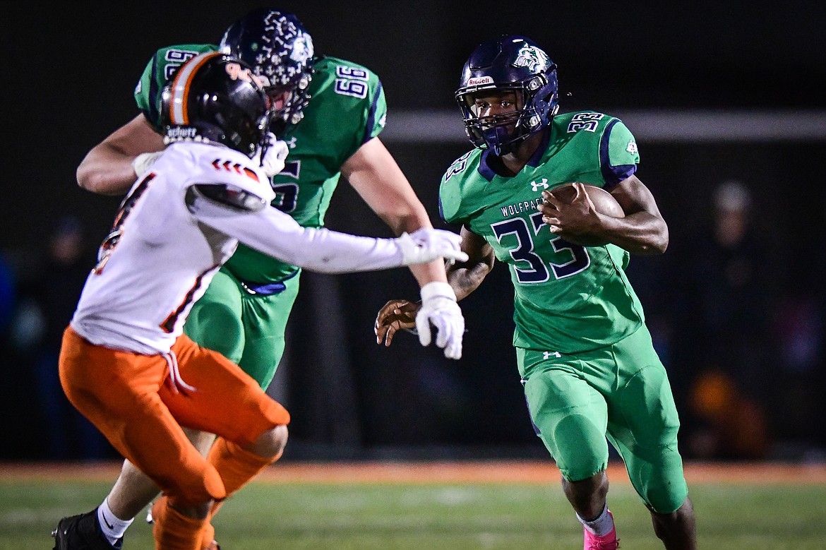 Glacier running back Kobe Dorcheus (33) picks up yardage on a run behind the blocking of offensive lineman Henry Sellards (66) in the second quarter against Flathead at Legends Stadium on Thursday, Oct. 5. (Casey Kreider/Daily Inter Lake)