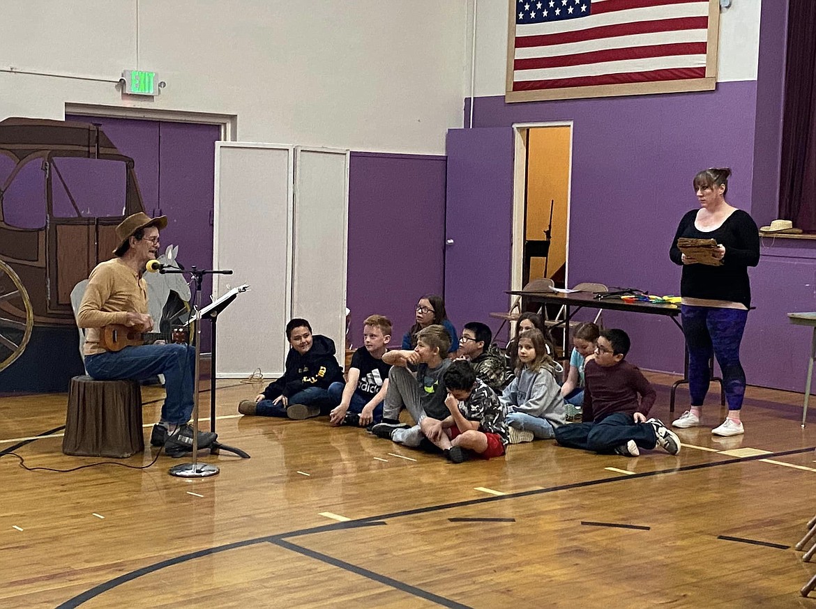 Paul Roberts sings during a performance at Mullan Elementary School. Paul and Carol Roberts are artists in residence working with students.