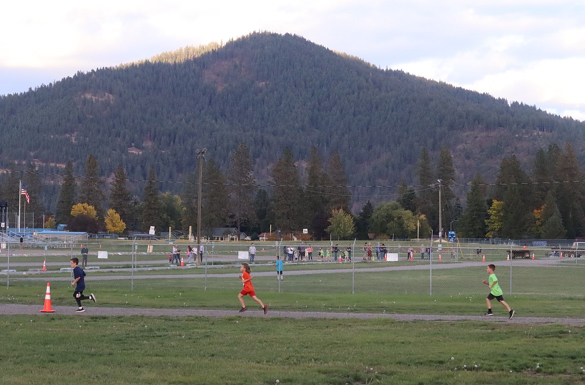 Runners pass Canfield Mountain in the Coeur d'Alene School District's annual elementary school cross country meet at the Kootenai County Fairgrounds on Thursday.