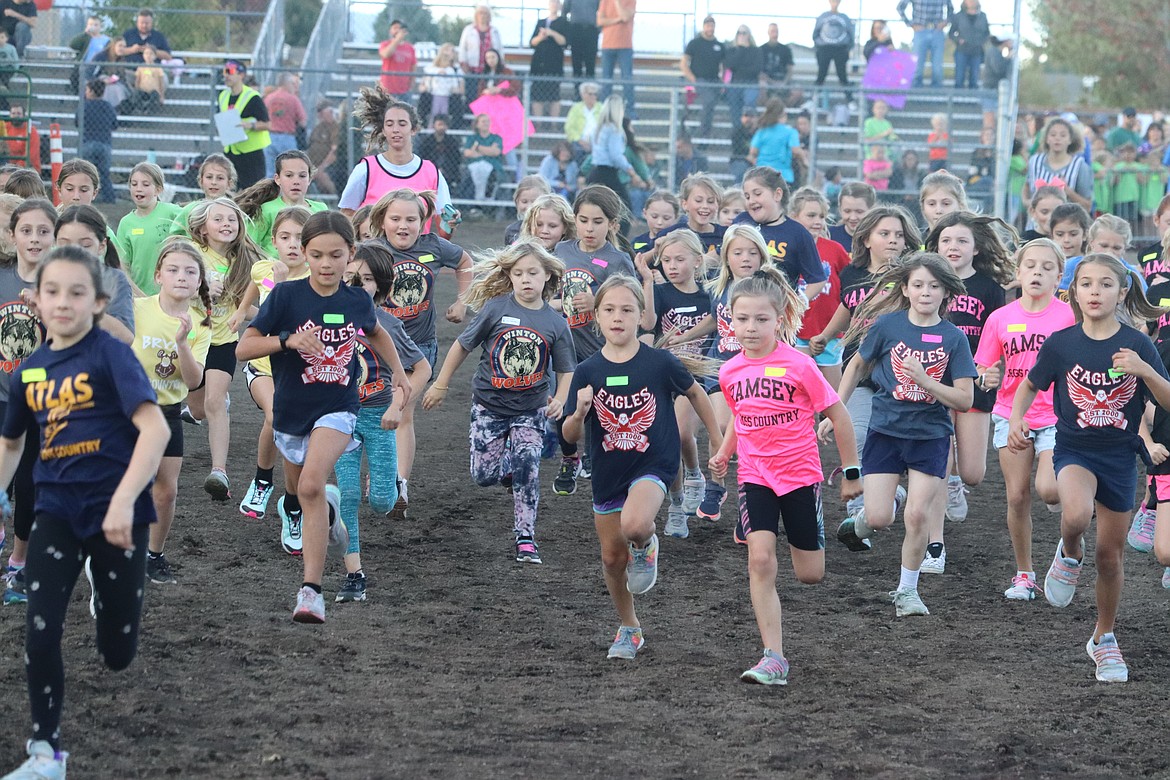 Girls charge away at the start of a race in the Coeur d'Alene School District's annual elementary school cross country meet Thursday