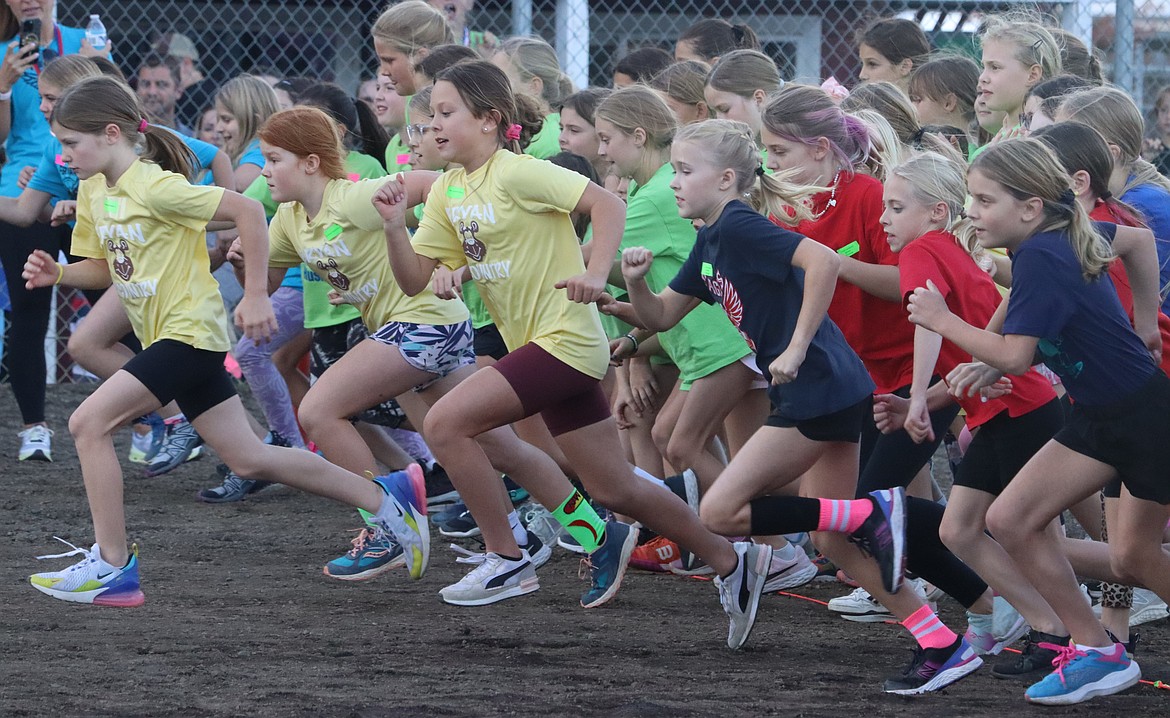 Girls tear away at start of their race in the Coeur d'Alene School District's annual elementary school cross country meet at the Kootenai County Fairgrounds on Thursday.