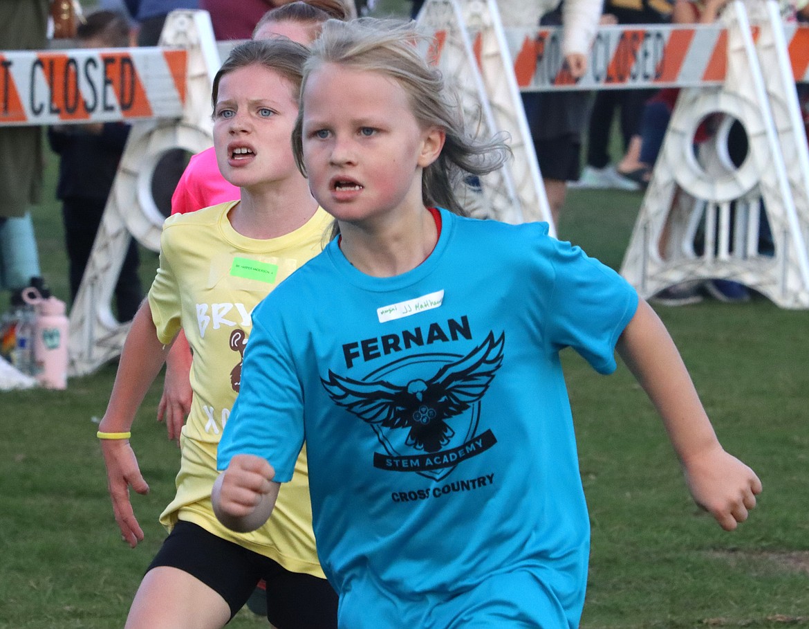 Bryan Elementary student Harper Andersen, left, and JJ Matthews of Fernan Elementary sprint to the finish line in the Coeur d'Alene School District's annual elementary school cross country meet at the Kootenai County Fairgrounds on Thursday.