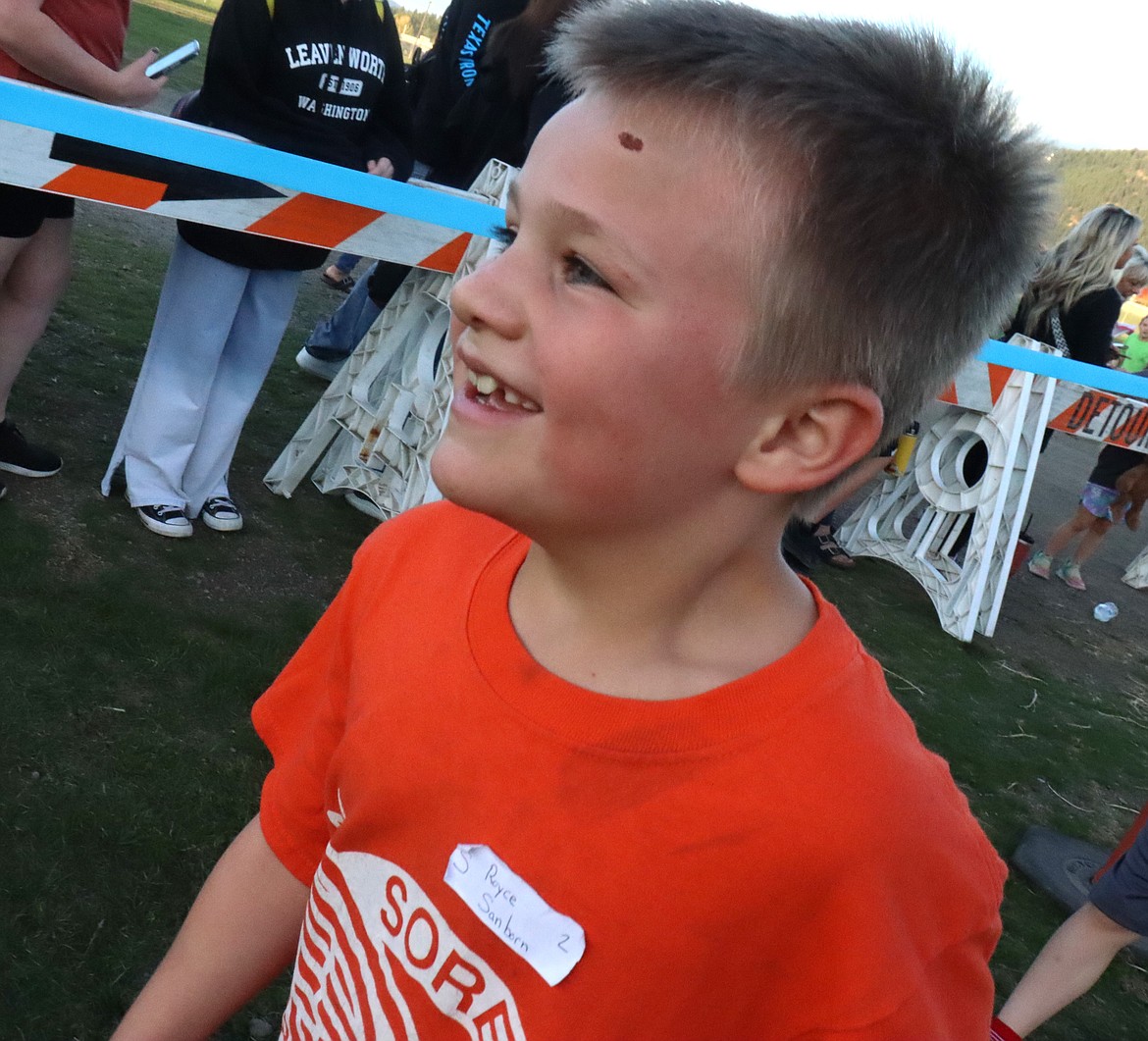 Second-grader Royce Sanborn smiles after finishing his one-mile race in the Coeur d'Alene School District's annual elementary school cross country meet at the Kootenai County Fairgrounds on Thursday.