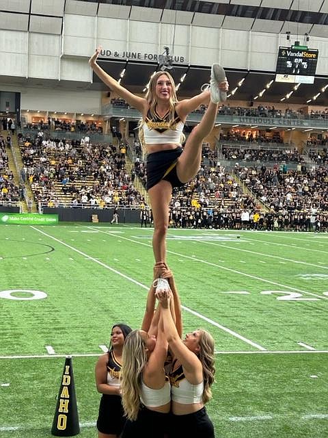 Sandpoint's Kendall Mitton stunts high in the air for the Vandal Cheer team at a recent University of Idaho home football game at the Kibbie Dome.