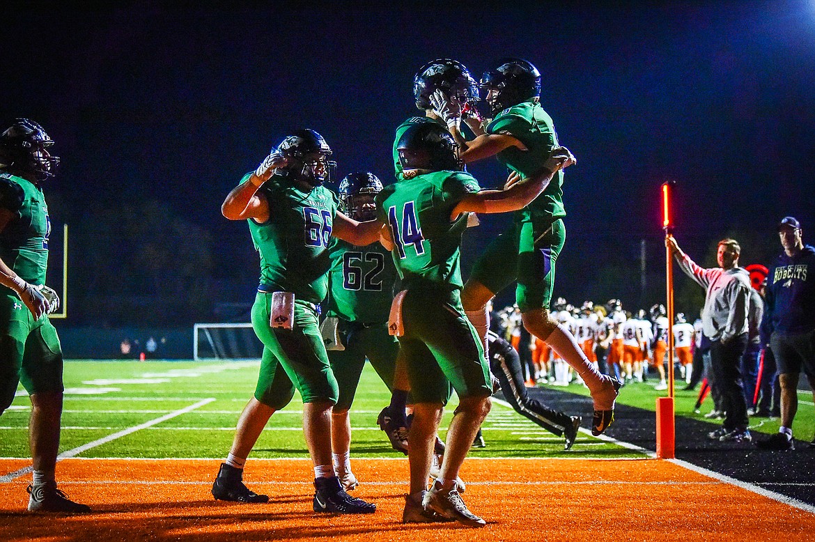 Glacier wide receiver Alex Hausmann (3) celebrates with quarterback Jackson Presley (12) and teammates after a 3-yard touchdown reception in the fourth quarter against Flathead at Legends Stadium on Thursday, Oct. 5. (Casey Kreider/Daily Inter Lake)