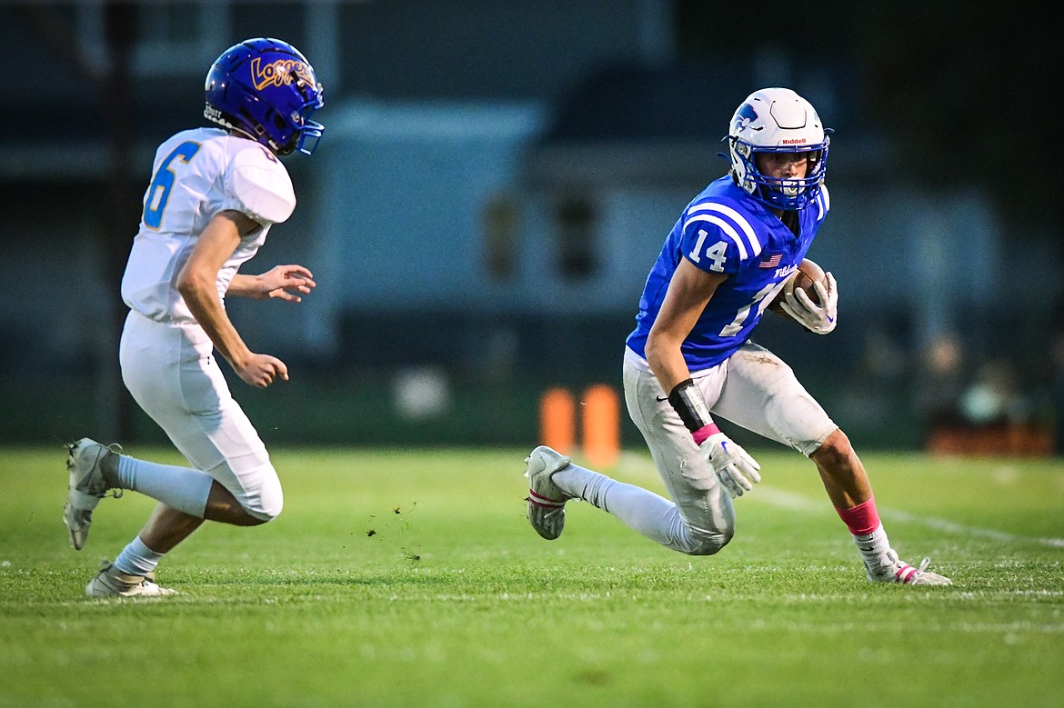 Columbia Falls wide receiver Jace Hill (14) picks up yardage before stepping out of bounds after a reception in the first quarter against Libby at Satterthwaite Field on Friday, Oct. 6. (Casey Kreider/Daily Inter Lake)