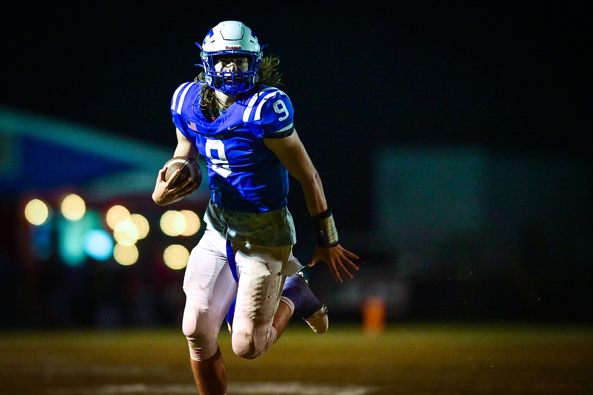 Columbia Falls quarterback Cody Schweikert (9) looks to run in the third quarter against Libby at Satterthwaite Field on Friday, Oct. 6. (Casey Kreider/Daily Inter Lake)