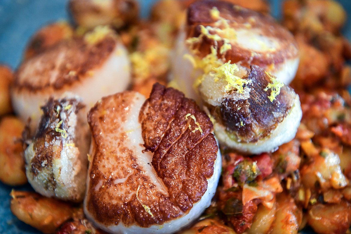 Butter-seared scallops with potato dumplings, sun dried tomato and arugula pesto, and crispy artichoke at Herb & Omni in Whitefish on Wednesday, Oct. 4. (Casey Kreider/Daily Inter Lake)