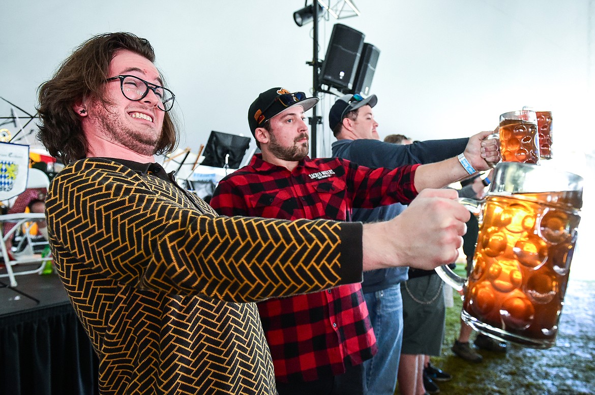 A competitor strains to keep his stein level during the mens' stein-holding contest at The Great Northwest Oktoberfest in Whitefish on Saturday, Oct. 7. (Casey Kreider/Daily Inter Lake)