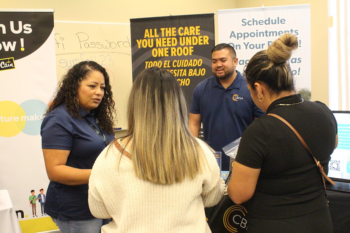 Representatives of Columbia Basin Health Association talk to job seekers during the WorkSource job fair Friday.