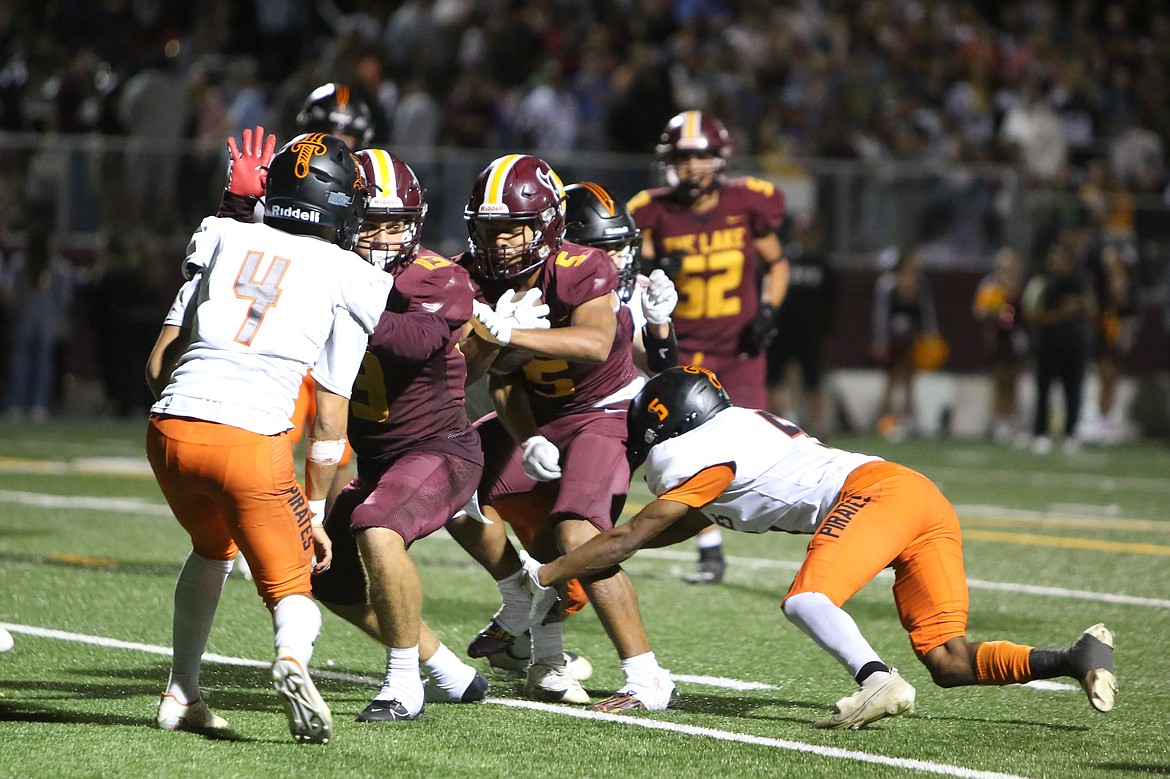 Moses Lake senior Hayden Throneberry (13) blocks for senior Kyson Thomas (5) on a touchdown in the third quarter against Davis.