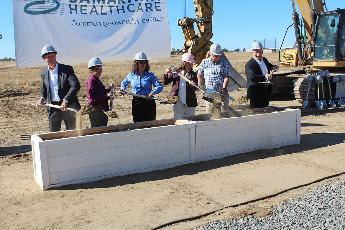 From left, Samaritan Healthcare Commissioners Dale Paris, Kathryn Christian and Susan Carbon, Chief Executive Officer Theresa Sullivan, and Commissioners Tom Frick and Alan White turn the ceremonial shovels of dirt at the groundbreaking for the new Samaritan Hospital Friday.