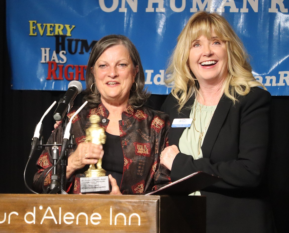 Susan Crowe, left, is joined by Christie Wood, Kootenai County Task Force on Human Relations president, as she receives the Bill Wassmuth Memorial Volunteer of the Year Award during the organization's 24th annual banquet Saturday night at the Best Western Plus Coeur d'Alene Inn.