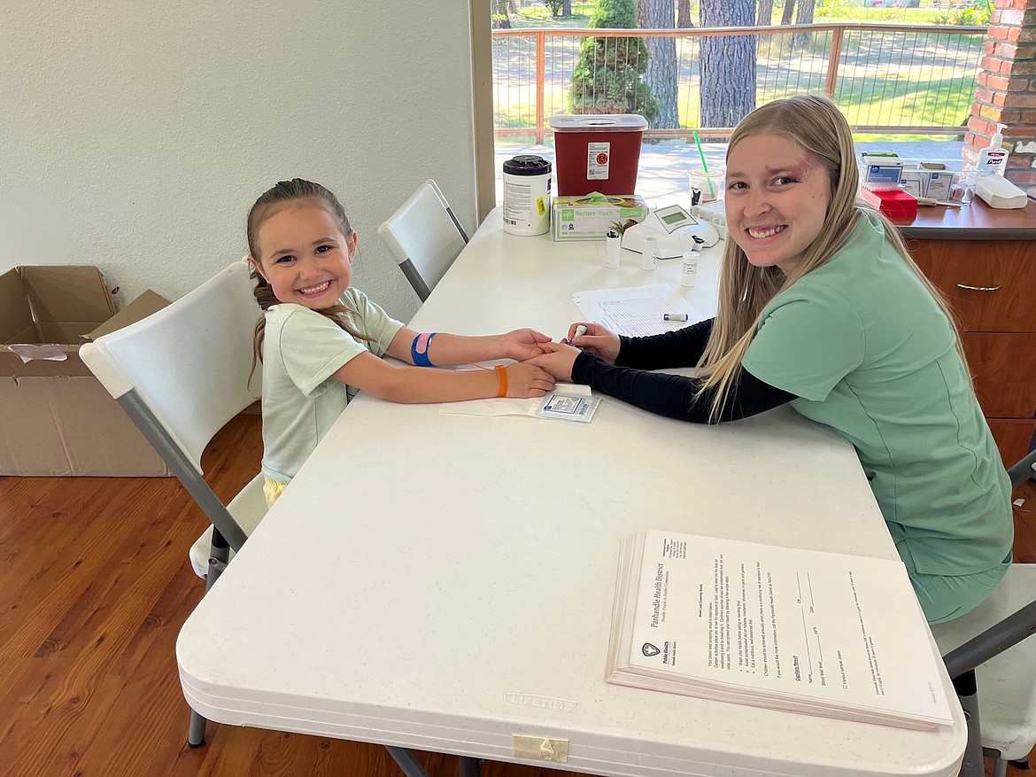 Violet Ploharz's blood is tested for exposure to lead by phlebotomist Kaitlin Tester of Shoshone Medical Center.